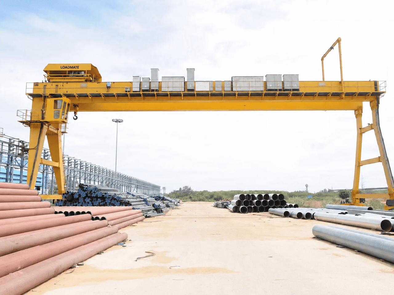 LOADMATE goliath gantry crane over an outdoor pipe yard
